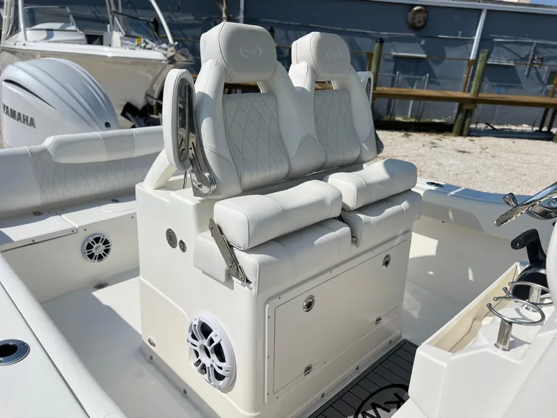 Slide: The Image of 2025 Key West 239FSR boat with white cushioned seats and built-in speakers. - 27