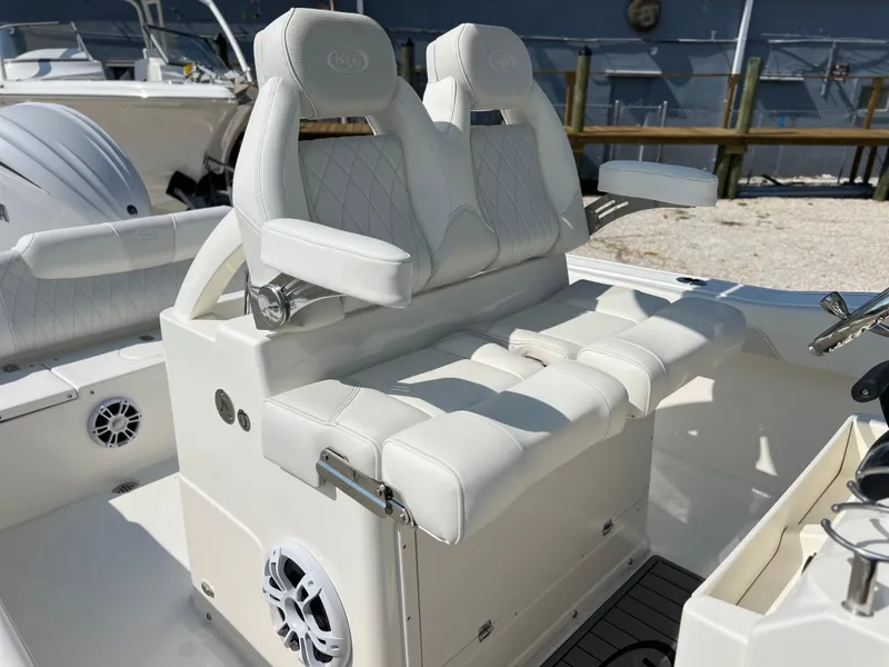 Slide: The Image of 2025 Key West 239FSR boat with white cushioned seating and built-in speaker. - 28