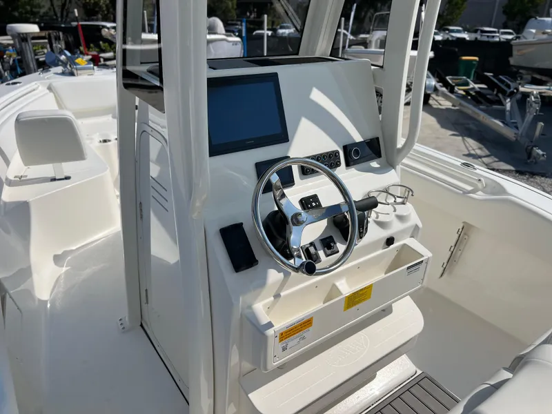 Slide: The Image of 2025 Key West 239FSR boat console with steering wheel and navigation display. - 29