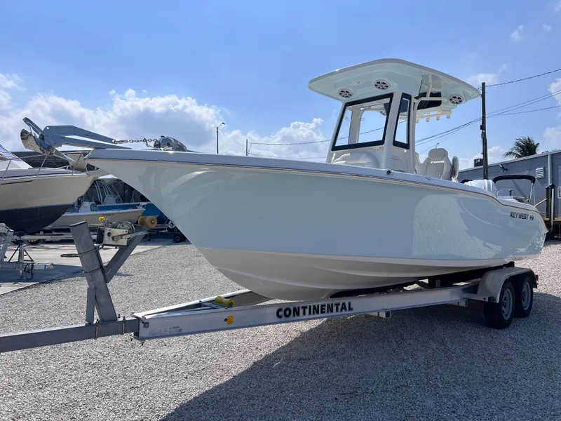 Slide: The Image of 2025 Key West 239FSR boat on trailer, displayed outdoors under a clear sky. - 3
