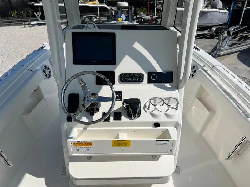 Slide: The Image of 2025 Key West 239FSR boat console with steering wheel, controls, and display screen. - 30