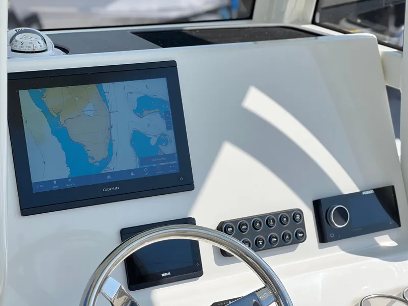 Slide: The Image of Dashboard of 2025 Key West 239FSR boat with navigation screen and controls. - 32