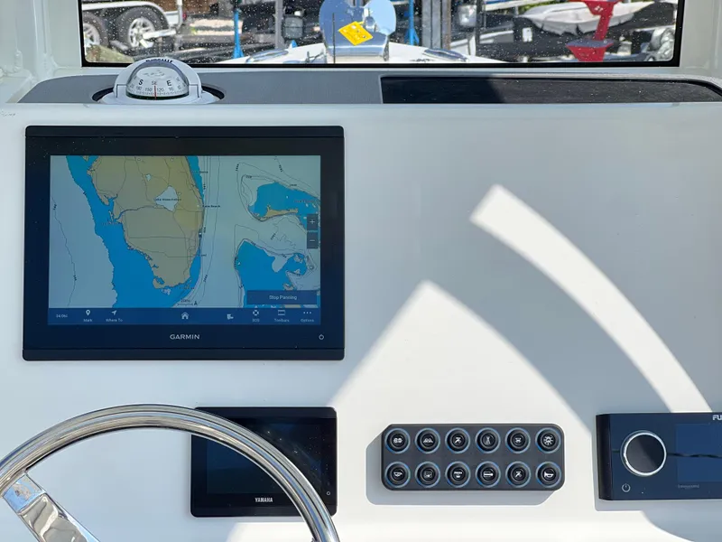 Slide: The Image of Key West 239FSR 2025 boat dashboard with navigation screen and controls. - 33
