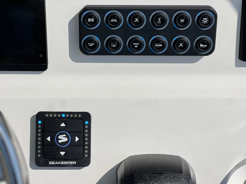 Slide: The Image of Control panel of 2025 Key West 239FSR boat featuring Seakeeper system and various buttons. - 34