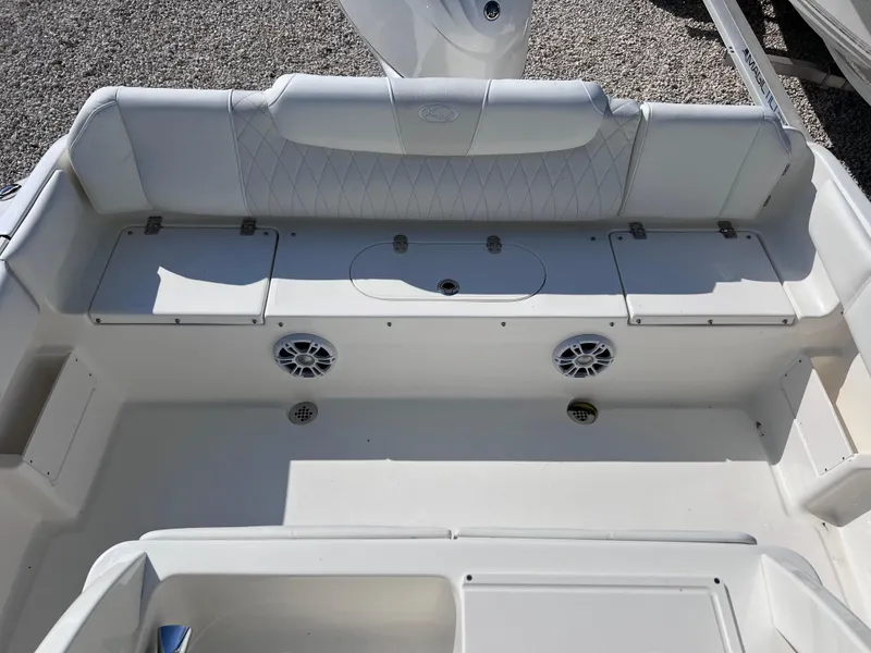 Slide: The Image of 2025 Key West 239FSR boat interior with white seating and built-in speakers. - 36