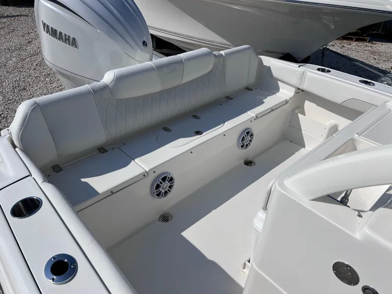 Slide: The Image of 2025 Key West 239FSR boat interior with Yamaha engine, featuring seating and cup holders. - 37