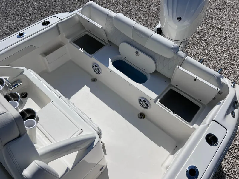 Slide: The Image of 2025 Key West 239FSR boat interior with seating, storage compartments, and cup holders. - 38