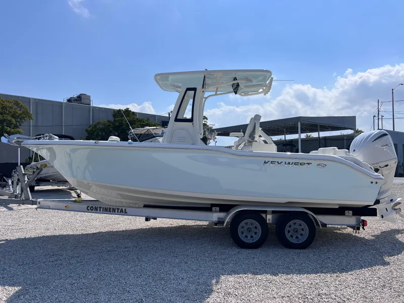 Slide: The Image of 2025 Key West 239FSR boat on trailer under clear sky. - 4