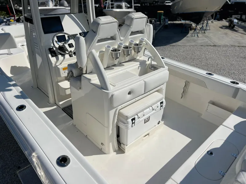 Slide: The Image of 2025 Key West 239FSR boat interior with dual seats and console, featuring a cooler storage. - 40