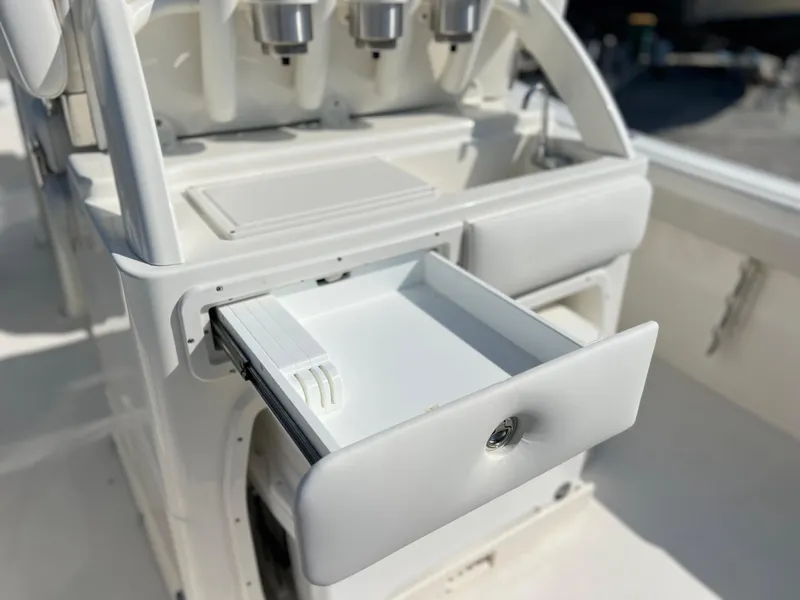 Slide: The Image of 2025 Key West 239FSR boat console with open storage drawer. - 42