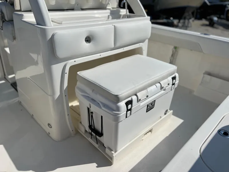 Slide: The Image of 2025 Key West 239FSR boat interior with cushioned cooler seat. - 43
