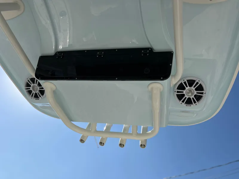Slide: The Image of 2025 Key West 239FSR boat underside with speakers and rod holders against blue sky. - 45