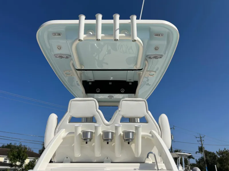 Slide: The Image of 2025 Key West 239FSR boat with sleek design and rod holders, under clear blue sky. - 47