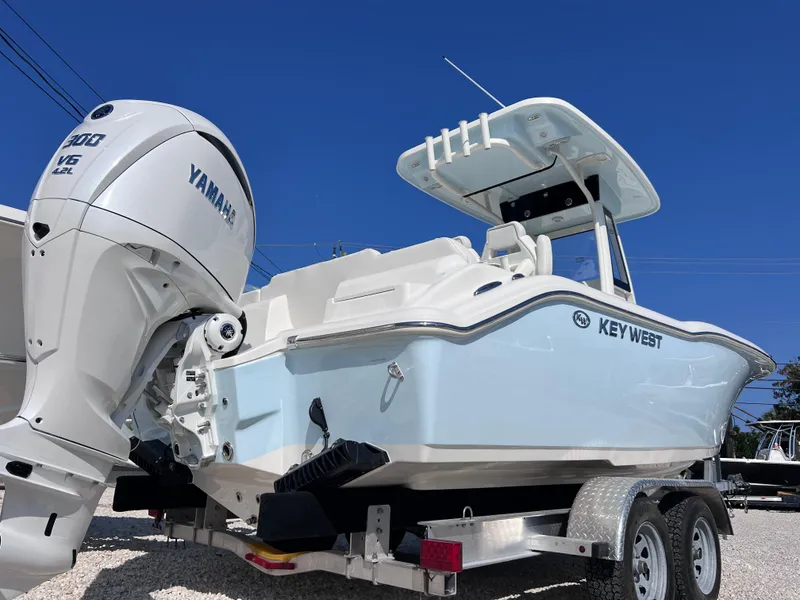 Slide: The Image of 2025 Key West 239FSR boat with Yamaha engine on trailer, under clear blue sky. - 48