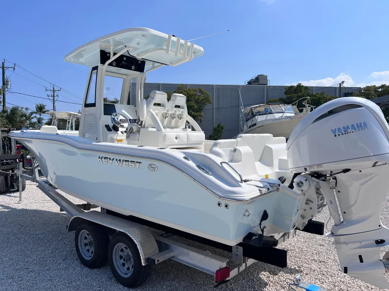 Slide: The Image of 2025 Key West 239FSR boat on trailer with Yamaha engine, parked outdoors. - 6