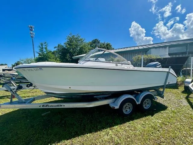 The Image of 2009 Edgewater 20 CX boat on trailer, parked outdoors under a clear blue sky. - 0