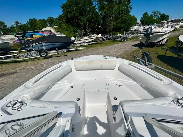 Slide: The Image of 2009 Edgewater 20 CX boat interior with seating, parked among other boats. - 3
