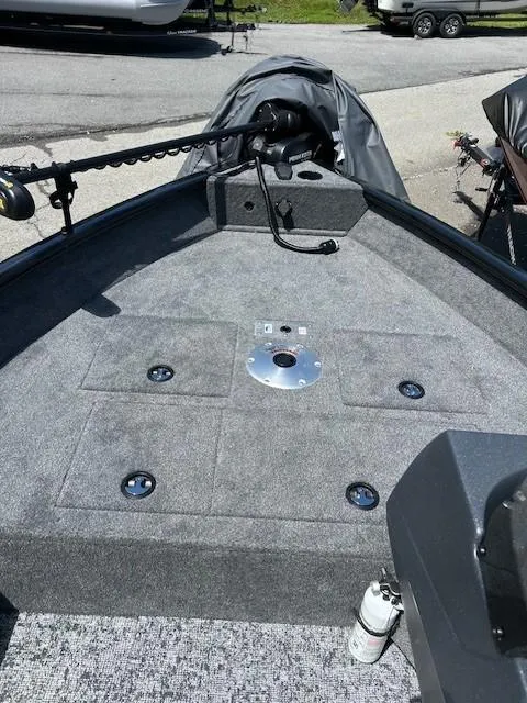 Slide: The Image of 2025 Tracker Pro Guide V-16 SC boat deck with storage compartments and fishing equipment. - 2