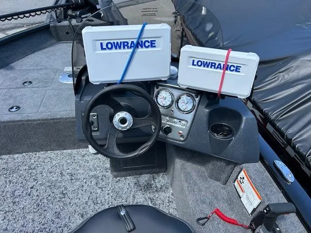 Slide: The Image of 2025 Tracker Pro Guide V-16 SC boat dashboard with Lowrance electronics and steering wheel. - 4