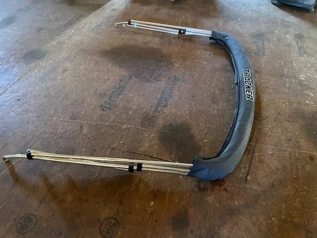 Slide: The Image of Bimini top frame for 2025 Tracker Pro Guide V-16 SC boat on wooden floor. - 9