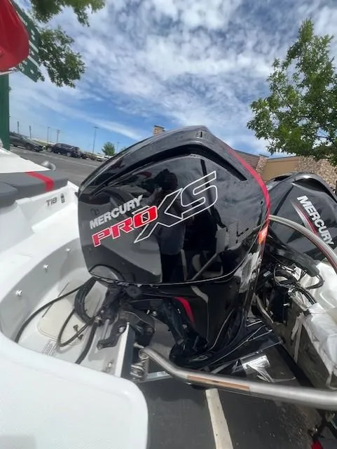 Slide: The Image of 2023 Tahoe T18 boat with Mercury Pro XS engine under a partly cloudy sky. - 11