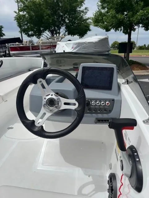 Slide: The Image of 2023 Tahoe T18 boat dashboard with steering wheel and control panel. - 7