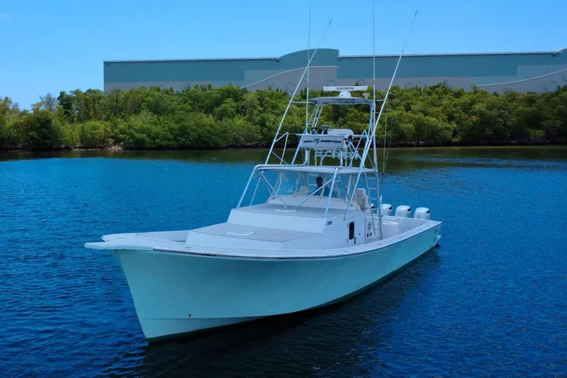 Slide: The Image of 2017 Chesapeake 53 Center Console boat on calm water near greenery. - 12