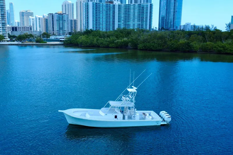 Slide: The Image of 2017 Chesapeake 53 Center Console boat on calm water with city skyline backdrop. - 14