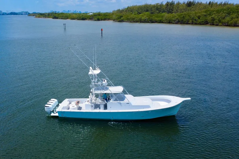 Slide: The Image of 2017 Chesapeake 53 Center Console boat on calm water, surrounded by lush greenery. - 15