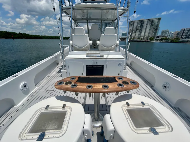 Slide: The Image of 2017 Chesapeake 53 Center Console boat with seating, rod holders, and city skyline in background. - 23