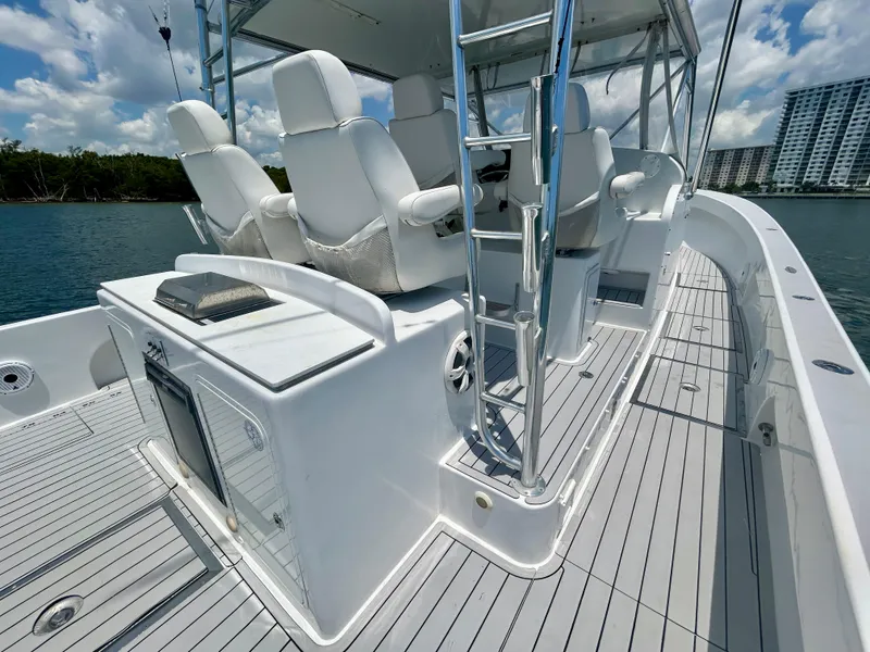 Slide: The Image of 2017 Chesapeake 53 Center Console boat with white seating and sleek design on calm water. - 27