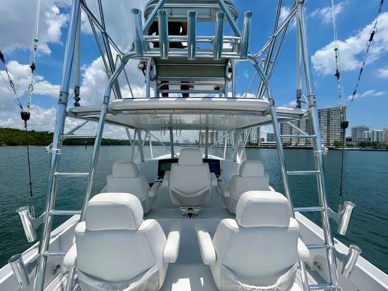 Slide: The Image of 2017 Chesapeake 53 Center Console boat with white seating, open water, and city skyline in background. - 30