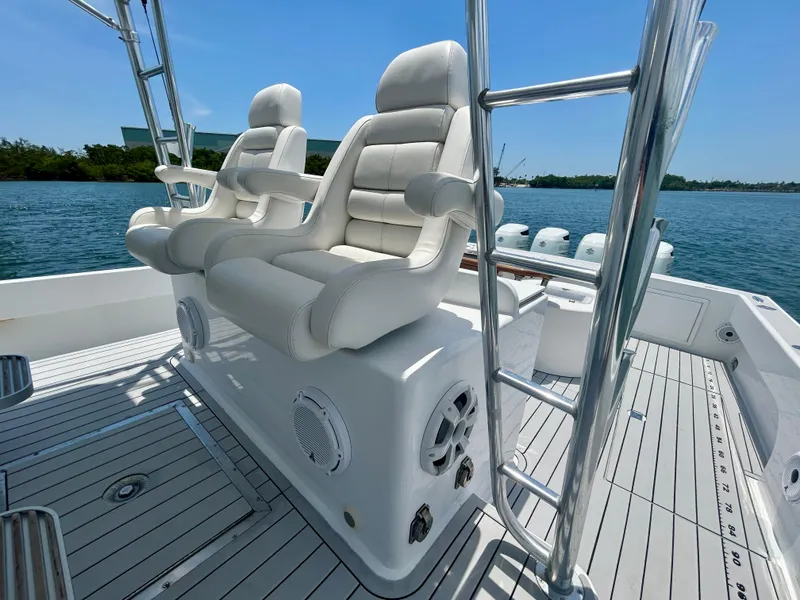 Slide: The Image of 2017 Chesapeake 53 Center Console boat with white seating and ocean backdrop. - 33