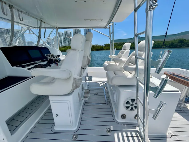 Slide: The Image of 2017 Chesapeake 53 Center Console boat interior with white seating and modern controls. - 35