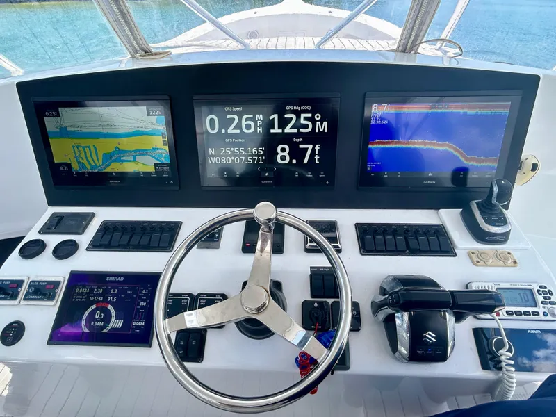 Slide: The Image of Control panel of a 2017 Chesapeake 53 Center Console boat with navigation screens. - 38