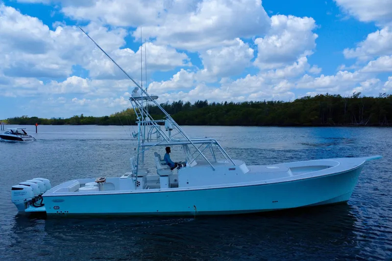 Slide: The Image of 2017 Chesapeake 53 Center Console boat on calm water under a cloudy sky. - 4