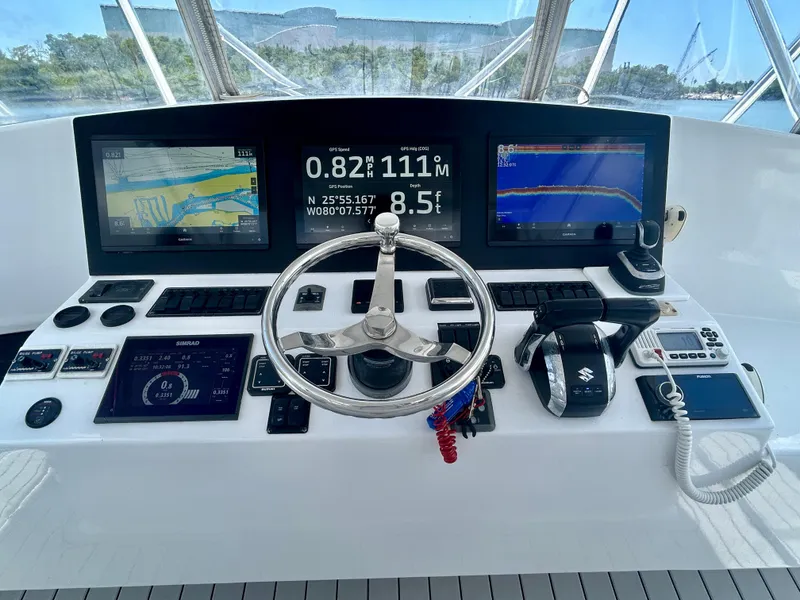Slide: The Image of Helm of 2017 Chesapeake 53 Center Console with navigation screens and controls. - 40