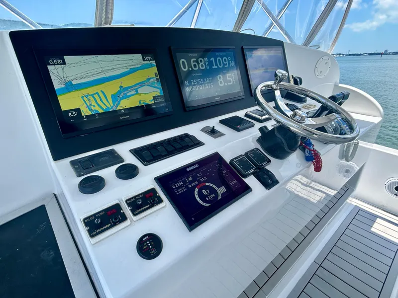 Slide: The Image of 2017 Chesapeake 53 Center Console helm with navigation screens and steering wheel. - 41