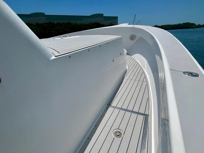Slide: The Image of 2017 Chesapeake 53 Center Console boat deck with sleek white design and ocean backdrop. - 46