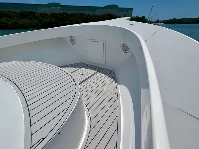 Slide: The Image of 2017 Chesapeake 53 Center Console boat deck with sleek white design and wood accents. - 47
