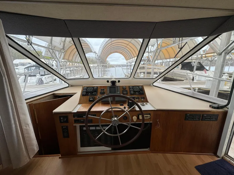 Slide: The Image of 1996 Skipperliner 560 Coastal Cruiser helm with panoramic marina view. - 13