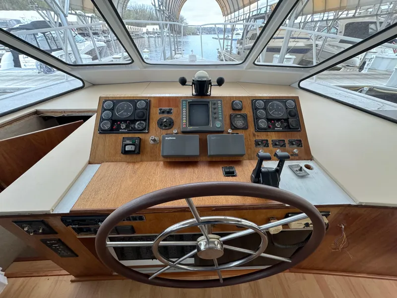 Slide: The Image of 1996 Skipperliner 560 Coastal Cruiser helm with wooden dashboard and steering wheel. - 14