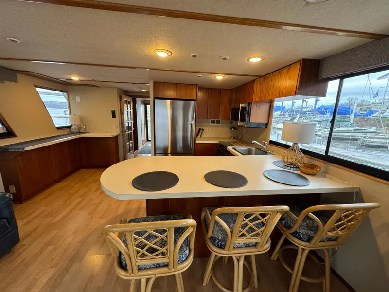 Slide: The Image of Interior of a 1996 Skipperliner 560 Coastal Cruiser with modern kitchen and bar seating. - 18
