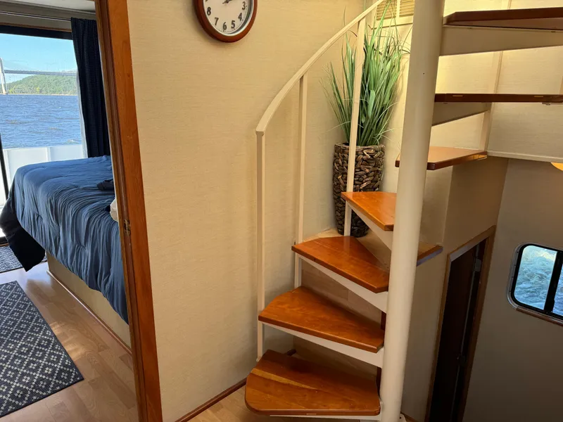 Slide: The Image of Interior of 1996 Skipperliner 560 Coastal Cruiser with spiral staircase and bedroom view. - 25