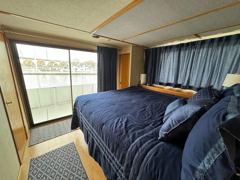 Slide: The Image of Luxurious bedroom in 1996 Skipperliner 560 Coastal Cruiser with waterfront view. - 27