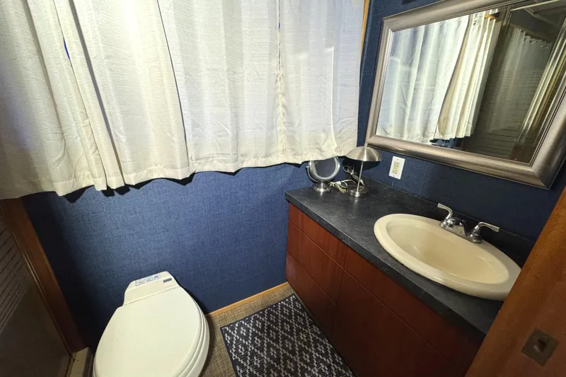 Slide: The Image of Bathroom interior of 1996 Skipperliner 560 Coastal Cruiser with sink, toilet, and mirror. - 35
