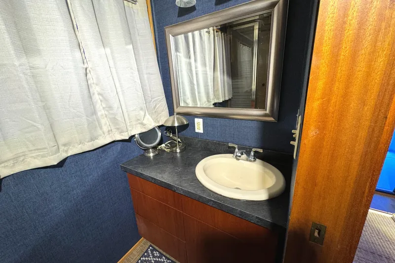 Slide: The Image of Bathroom interior of 1996 Skipperliner 560 Coastal Cruiser with sink and mirror. - 36