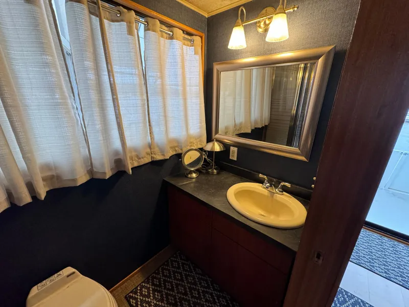 Slide: The Image of Bathroom interior of 1996 Skipperliner 560 Coastal Cruiser with sink, mirror, and lighting. - 37