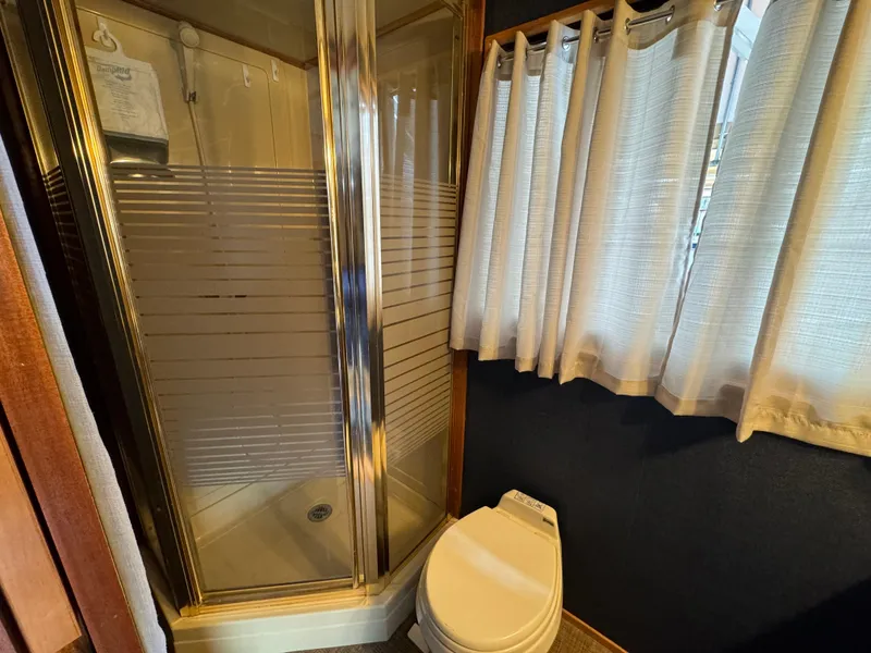 Slide: The Image of Bathroom interior of 1996 Skipperliner 560 Coastal Cruiser with shower and toilet. - 38
