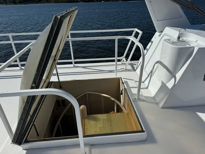 Slide: The Image of Open hatch on 1996 Skipperliner 560 Coastal Cruiser, revealing stairs to lower deck. - 4